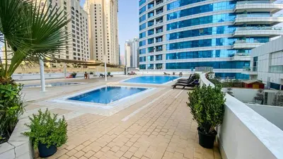 a swimming pool in a city with tall buildings at Sea Breeze Luxury 2BR, Dubai Marina, Big Terrace, Near Beach, Pool access, by Stay Vista! for up to 6 Guests in Dubai