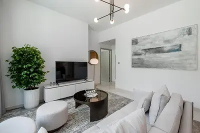 a white living room with a couch and a table at Beach Isle 1 Emaar Beachfront - Mint Stay in Dubai