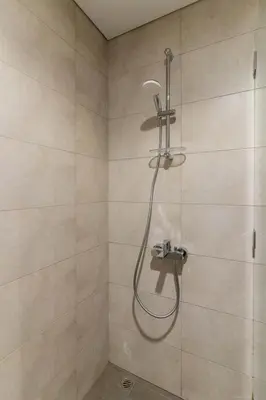 a shower with a shower head in a bathroom at Modern 1BR in Aykon City - Near Burj Khalifa & Canal in Dubai