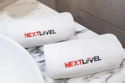 two towels on a counter with the words revealed on them at Modern 1BR in Aykon City - Near Burj Khalifa & Canal in Dubai