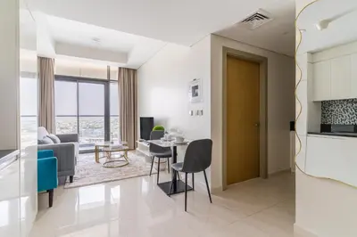 a living room with a table and chairs at Modern 1BR in Aykon City - Near Burj Khalifa & Canal in Dubai