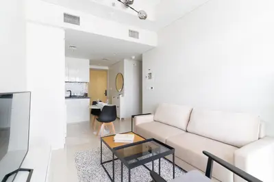a living room with a couch and a table at Business Bay 1br with High-Floor Views in Dubai