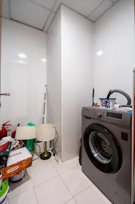 a laundry room with a washing machine in it at Luxury 2BR with Canal & Pool View Nr Downtown in Dubai