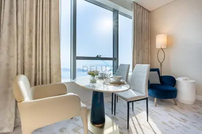 a room with a table and chairs and a large window at Steps from Nakheel Mall and Monorail Station, Near Beach Clubs ,15 Mins to Downtown and Marina, The Palm Tower, Palm Jumeirah by Deluxe Holiday Homes in Dubai
