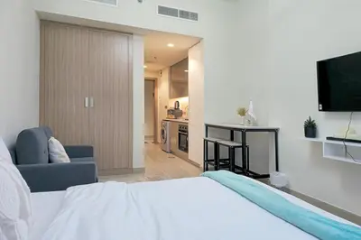 a bedroom with a bed and a living room at Azizi Riviera 43 - Meydan by Golden Casa in Dubai