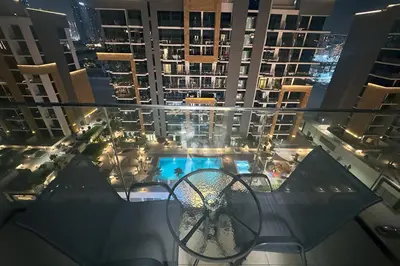 a view of a balcony of a building with a pool at Azizi Riviera 43 - Meydan by Golden Casa in Dubai