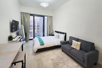 a bedroom with a bed and a couch at Azizi Riviera 43 - Meydan by Golden Casa in Dubai