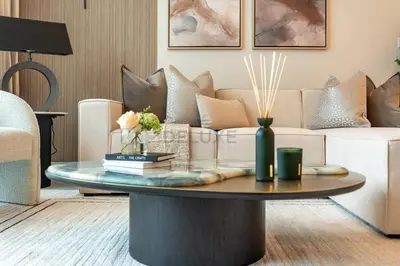 a living room with a couch and a coffee table at Steps from Marina Beach, AquaFun & The Walk, Mins to Bluewaters Island and Ain Dubai - La Vie, Jumeirah Beach Residence by Deluxe Holiday Homes in Dubai