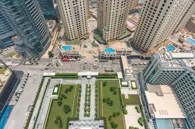 an aerial view of a city with tall buildings at Steps from Marina Beach, AquaFun & The Walk, Mins to Bluewaters Island and Ain Dubai - La Vie, Jumeirah Beach Residence by Deluxe Holiday Homes in Dubai