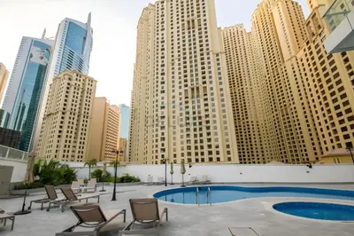 a pool in the middle of a city with tall buildings at Seamless Access to Marina Mall, JBR Beach, Dining And Shopping Spots, Just A Few Meters from the Tram Station - Continental Tower, Dubai Marina by Deluxe Holiday Homes in Dubai