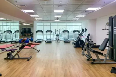 a gym with treadmills and elliptical machines at Seamless Access to Marina Mall, JBR Beach, Dining And Shopping Spots, Just A Few Meters from the Tram Station - Continental Tower, Dubai Marina by Deluxe Holiday Homes in Dubai