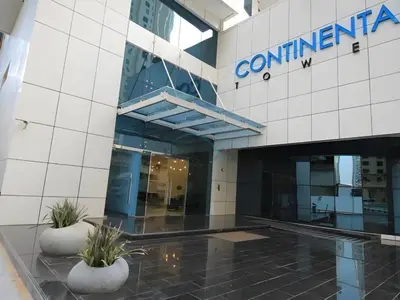 a building with a sign on the side of it at Seamless Access to Marina Mall, JBR Beach, Dining And Shopping Spots, Just A Few Meters from the Tram Station - Continental Tower, Dubai Marina by Deluxe Holiday Homes in Dubai