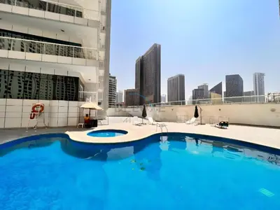 a large swimming pool on the roof of a building at Seamless Access to Marina Mall, JBR Beach, Dining And Shopping Spots, Just A Few Meters from the Tram Station - Continental Tower, Dubai Marina by Deluxe Holiday Homes in Dubai