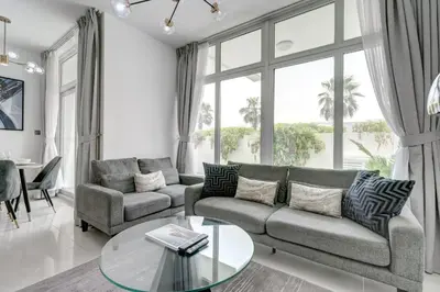 a living room with a couch and a glass table at PVH - Chic 3BR Villa with Backyard - Albizia in Dubai
