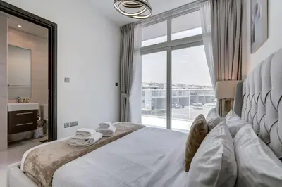 a bedroom with a white bed with a large window at PVH - Chic 3BR Villa with Backyard - Albizia in Dubai