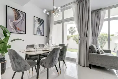 a dining room with a table and chairs at PVH - Chic 3BR Villa with Backyard - Albizia in Dubai