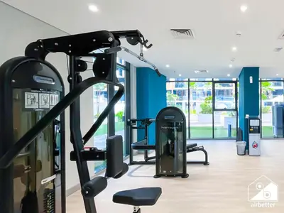 a gym with cardio equipment in a building at Amazing Studio in Meydan l Pool , Gym & Balcony in Dubai