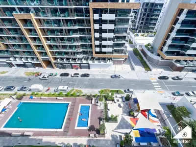 an overhead view of a pool in front of apartment buildings at Amazing Studio in Meydan l Pool , Gym & Balcony in Dubai