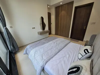 a bedroom with a bed with a blanket on it at Stylish 1-Bedroom Apartment in Dubai