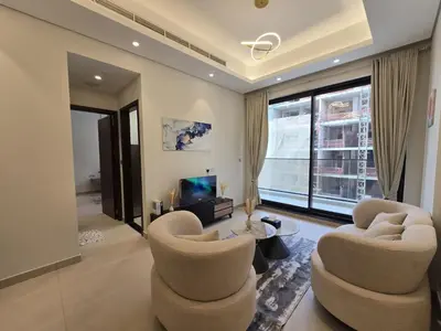 a living room with two chairs and a television at Stylish 1-Bedroom Apartment in Dubai