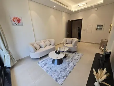 a living room with two chairs and a table at Stylish 1-Bedroom Apartment in Dubai