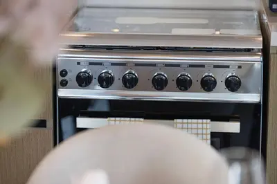 a stove top oven sitting in a kitchen at Mahogany 17 - 2BR 10PAX - On the Boulevard Sea View in Dubai