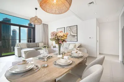 a dining room with a wooden table and chairs at Mahogany 17 - 2BR 10PAX - On the Boulevard Sea View in Dubai