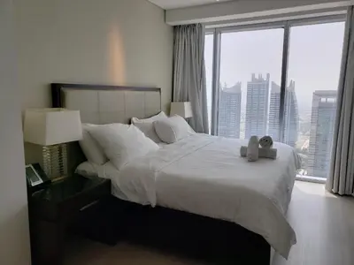 a bedroom with a bed with two teddy bears on it at Deluxe 1 BR At Address Apartments Marina Mall by Primevanguard in Dubai