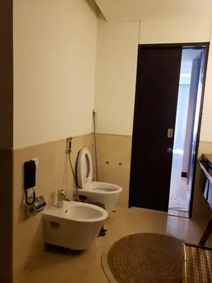 a bathroom with a toilet and a sink and a door at Deluxe 1 BR At Address Apartments Marina Mall by Primevanguard in Dubai