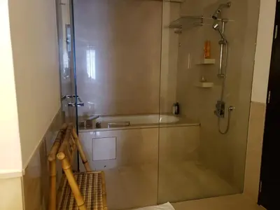a shower with a glass door in a bathroom at Deluxe 1 BR At Address Apartments Marina Mall by Primevanguard in Dubai