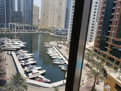 a view of a marina with boats in the water at Deluxe 1 BR At Address Apartments Marina Mall by Primevanguard in Dubai