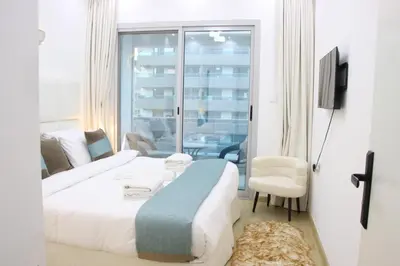 a hotel room with a bed and a balcony at Dubai Marina 1BR with Balcony, Near Metro, Walk to JBR beach & Marina Promenade in Dubai