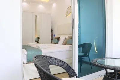 a room with a bed and a table and chairs at Dubai Marina 1BR with Balcony, Near Metro, Walk to JBR beach & Marina Promenade in Dubai