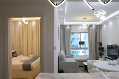 a bedroom with a bed and a living room at Dubai Marina 1BR with Balcony, Near Metro, Walk to JBR beach & Marina Promenade in Dubai