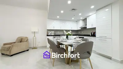 a kitchen and dining room with a table and chairs at Birchfort- Downtown Living with Burj Khalifa View in Dubai