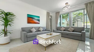 a living room with a couch and a table at Birchfort- Downtown Living with Burj Khalifa View in Dubai