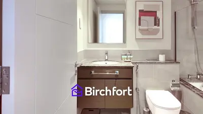a bathroom with a white toilet and a sink at Elegant Flat in Prime Location in Dubai