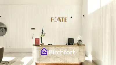 a table in a room with a sign on the wall at Elegant Flat in Prime Location in Dubai