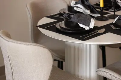 a table with a hat on it with chairs at Trendy 2BR Apartment near Burj Khalifa, Downtown Dubai in Dubai