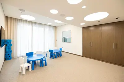 a waiting room with blue tables and chairs and cabinets at Trendy 2BR Apartment near Burj Khalifa, Downtown Dubai in Dubai
