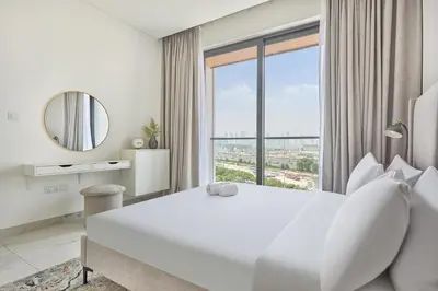 a bedroom with a large white bed and a large window at STAY BY LATINEM Luxury 2BR Holiday Home OPA 305 Near Downtown in Dubai