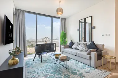 a living room with a couch and a table at STAY BY LATINEM Luxury 2BR Holiday Home OPA 305 Near Downtown in Dubai