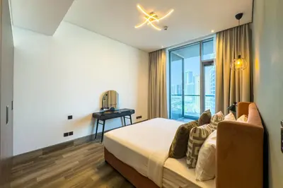 a bedroom with a bed and a window at Stylish 1B in J one With Balcony & Canal View in Dubai