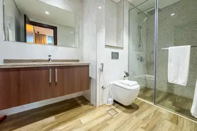 a bathroom with a toilet and a shower at 1BR City Escape l Canal & Skyline Views in Dubai