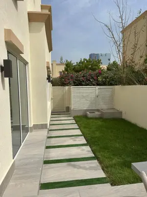 a walkway in a yard next to a building at Luxury 4 Bedroom Villa The Springs Dubai in Dubai