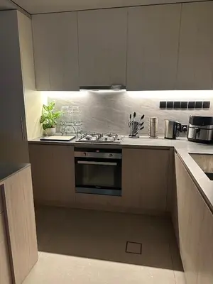 a kitchen with white cabinets and a stove top oven at Luxury 4 Bedroom Villa The Springs Dubai in Dubai