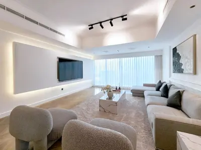 a living room with a couch and a tv at SOLARTE Luxe - New Large 2BR - Marina Promenade - Sea Views - Super King Bed & Workspace in Dubai