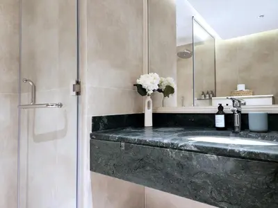a bathroom with a sink and a mirror at SOLARTE Luxe - New Large 2BR - Marina Promenade - Sea Views - Super King Bed & Workspace in Dubai
