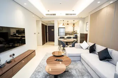 a living room with a couch and a table at Spacious Luxe 2BR in Dubai - With Pool and Gym in Dubai