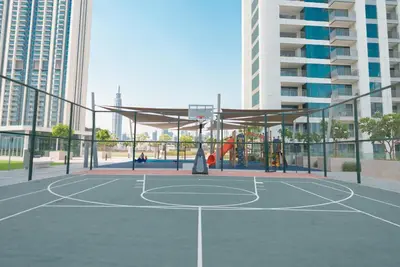 a basketball court in a city with tall buildings at Luxury2BR BurjKhalifa View Infinity Pool Mall Walk in Dubai